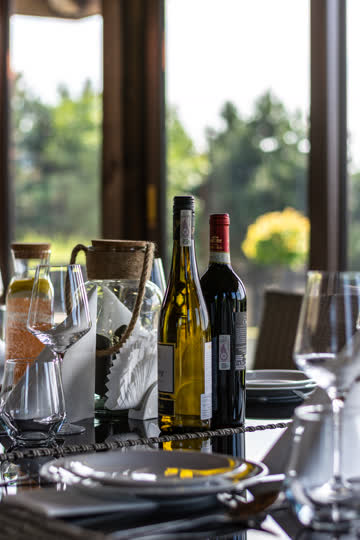 Wino i szkło na nakrytym stole – Hotel Stara Kuźnia w Kornatce koło Dobczyc